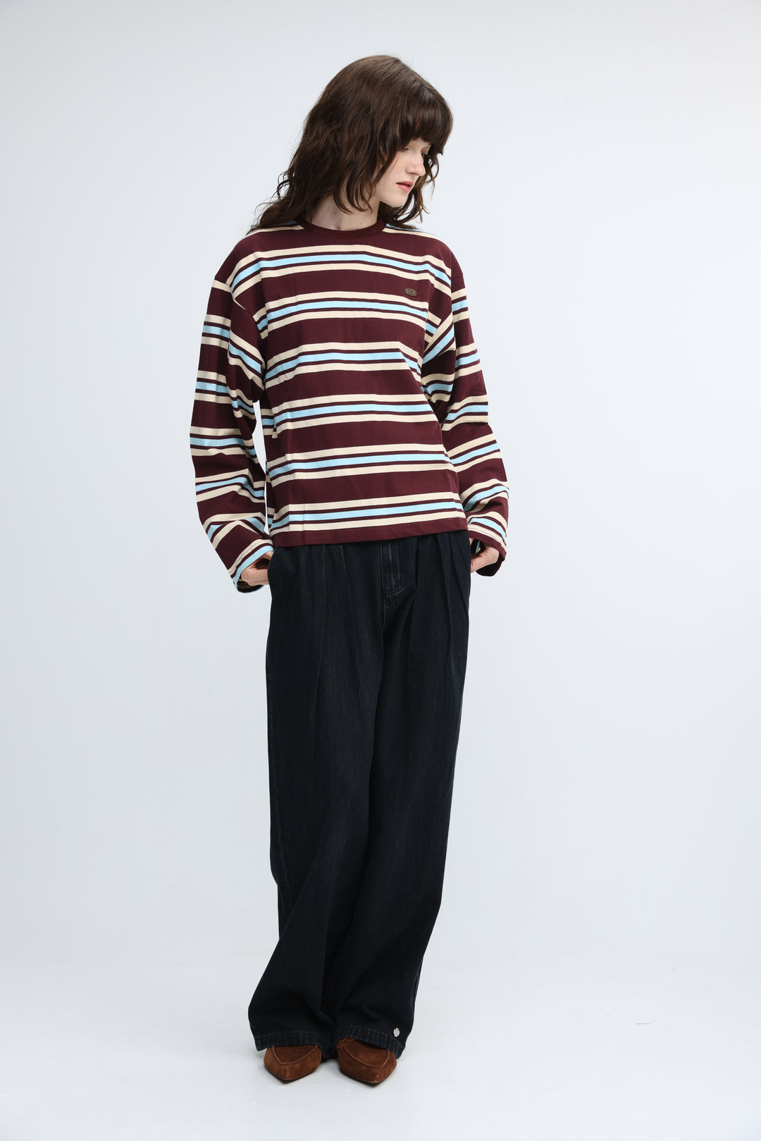 Maroon and cream striped long-sleeved sweater with small embroidered logo on the chest front view
