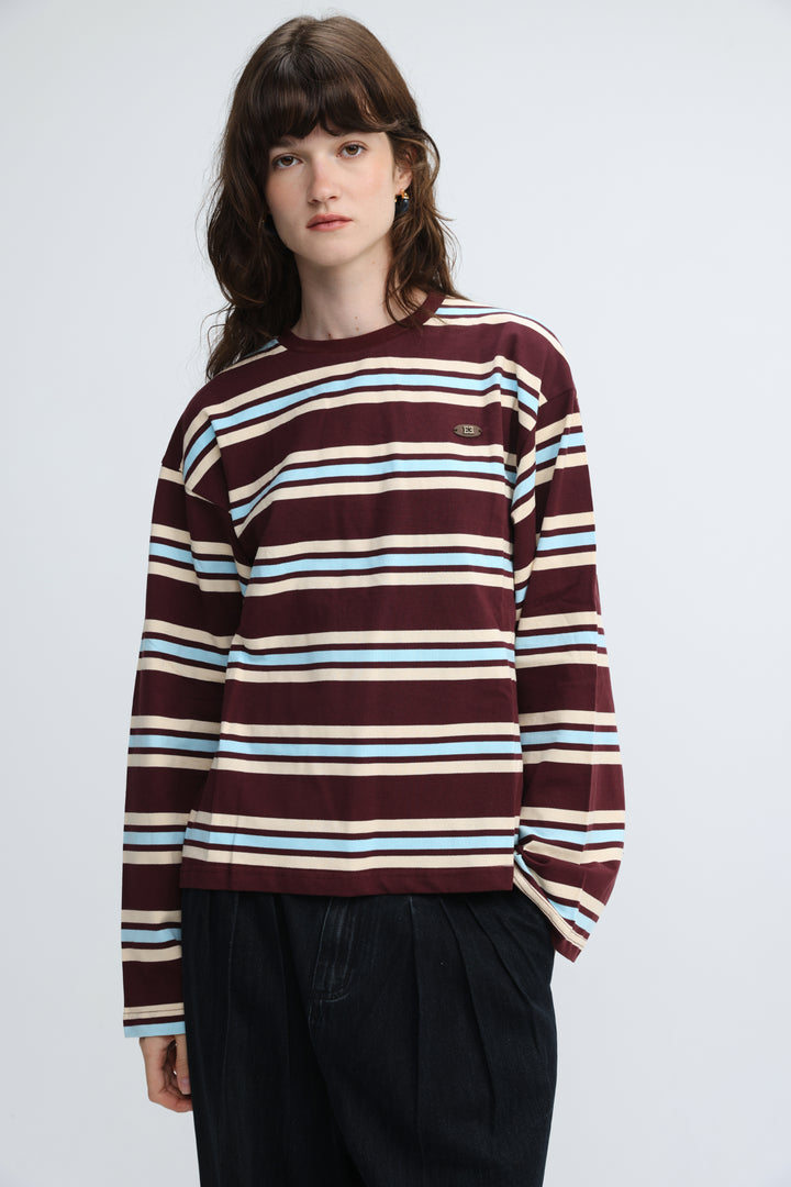 Maroon wine striped long-sleeve crewneck sweater with light blue and cream stripes and small embroidered logo on left chest