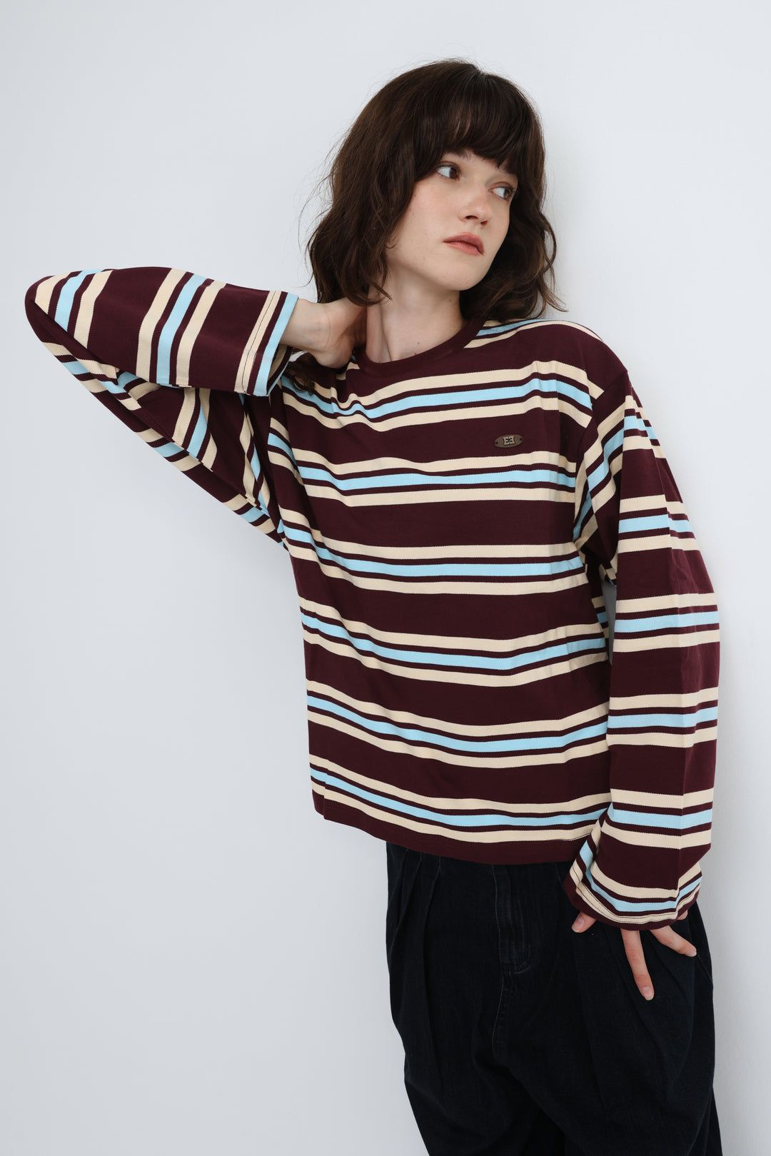 Front view of a federer wine striped long-sleeve crewneck top with maroon beige and light blue stripes and a small embroidered logo