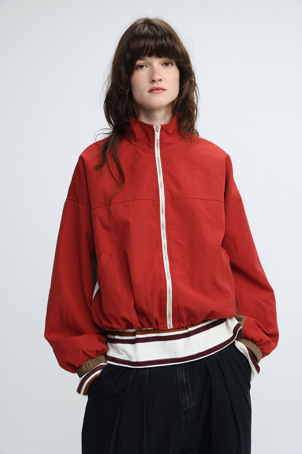 Madas red bomber jacket with white zipper and striped cuffs shown from the front