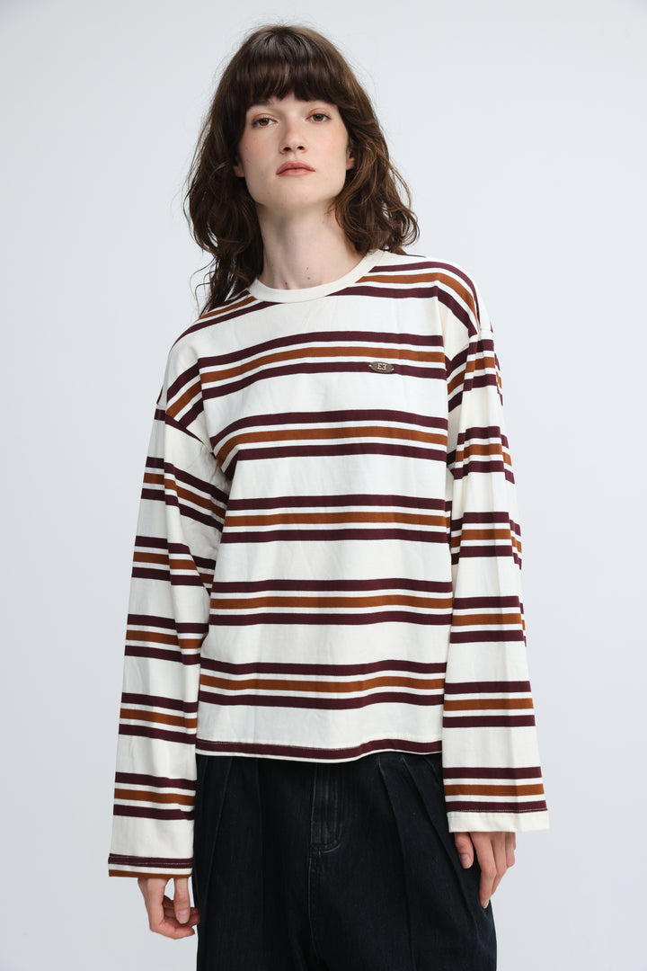 The Federer cream striped shirt is a long-sleeved crew-neck sweater with horizontal cream, brown, and maroon stripes