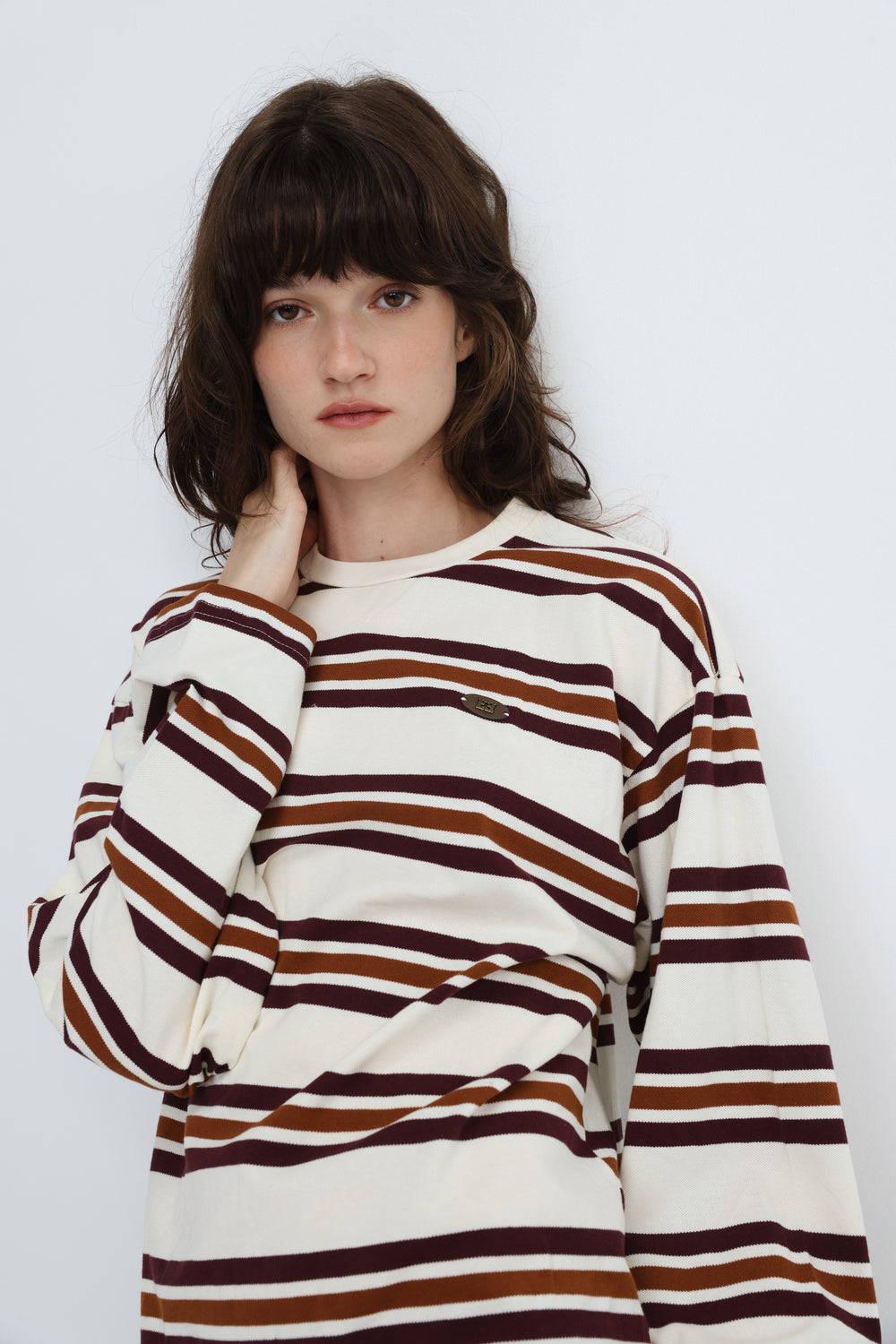 Federer cream long-sleeved striped sweater with brown and maroon hues and a subtle chest brand patch front view
