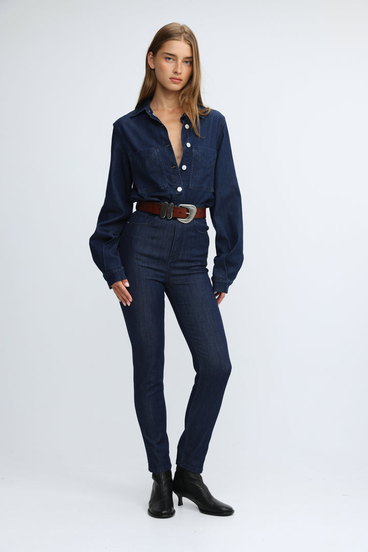 Dark blue denim shirt with button-down front and chest pockets paired with matching high-waisted jeans front view