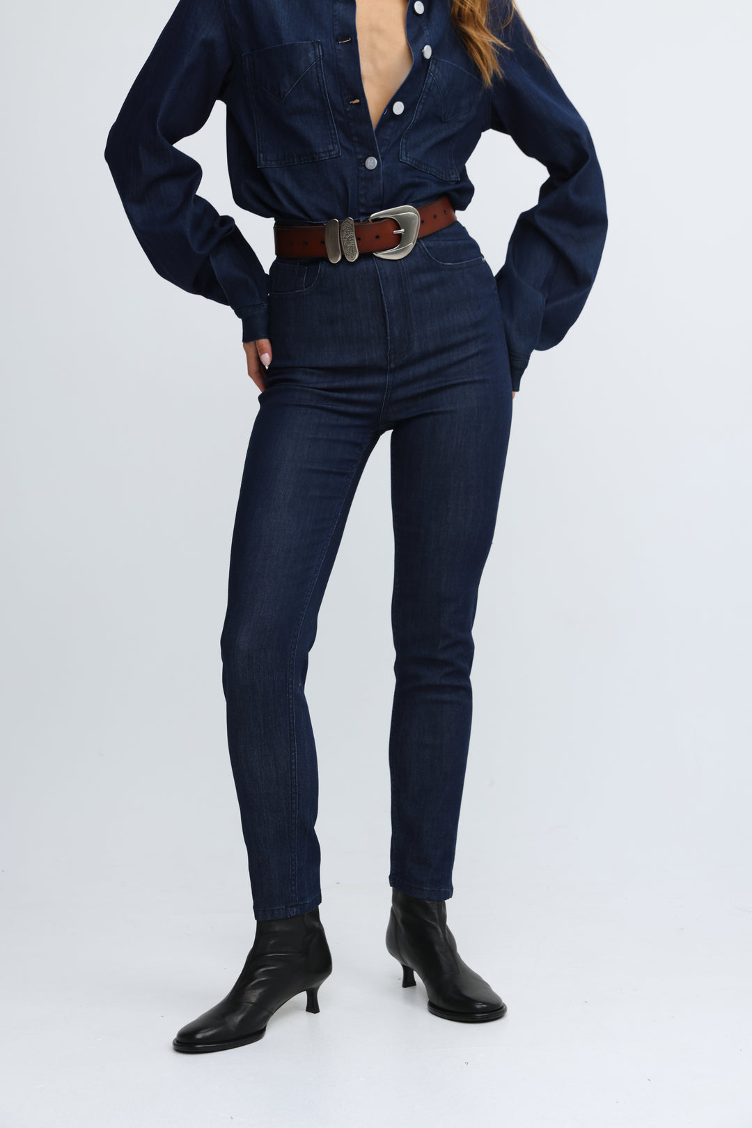 Dark blue high-waisted slim fit jeans with subtle vertical ribbing along the legs shown from the front