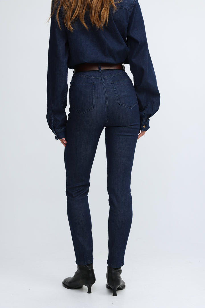 Dark blue high-waisted skinny jeans with classic denim texture and subtle stitching details shown from the front view