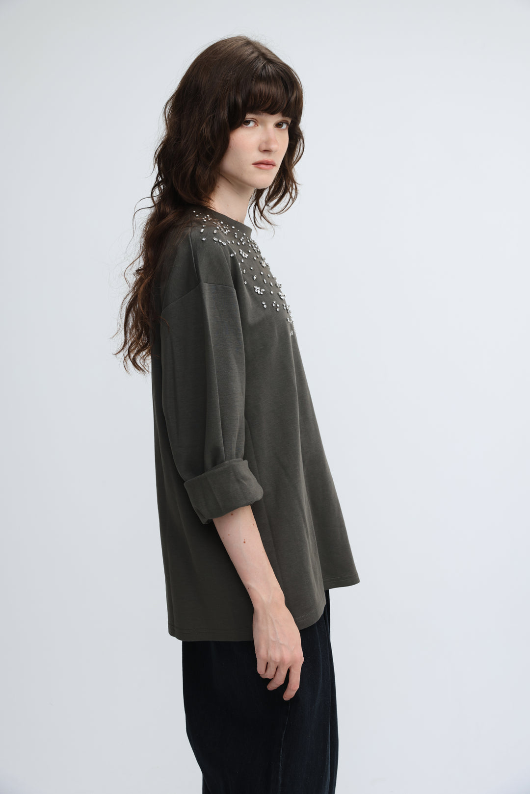 Dark olive green blouse with subtle sheen and silver stud embellishments across neckline and shoulder area