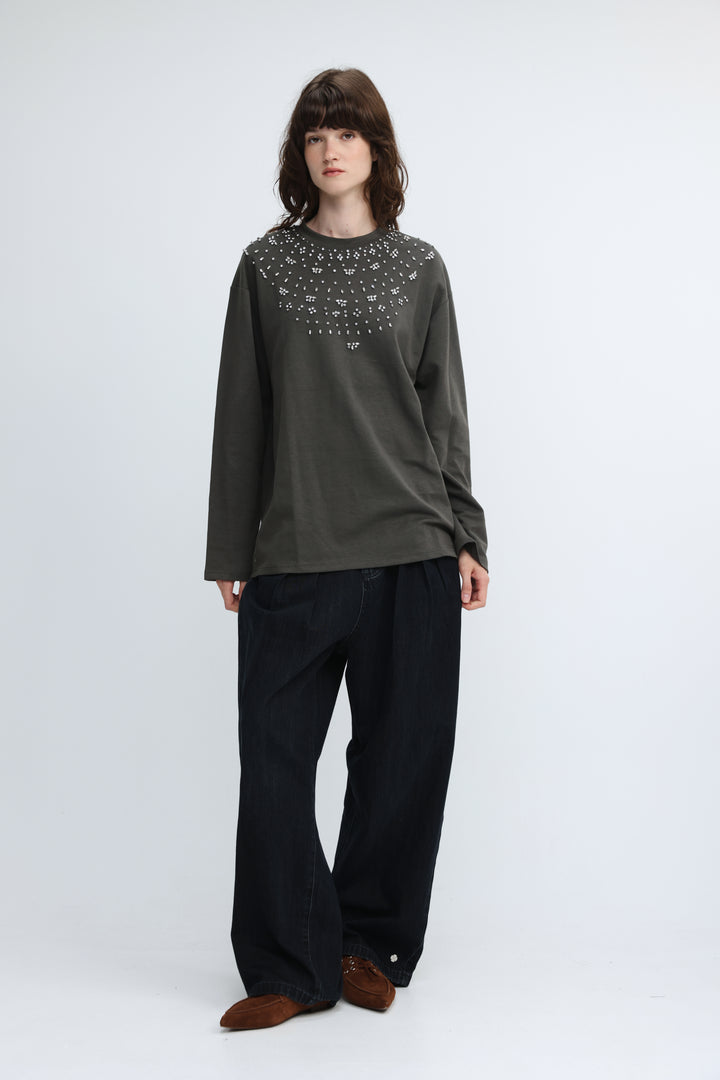 Olive green long-sleeved top with a decorative studded neckline shown from the front titled coco grey shirt