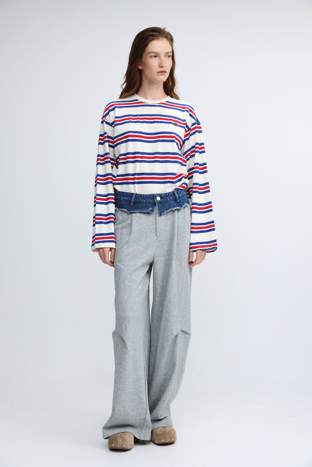A woman wearing a long-sleeved Federer blue striped shirt with red, white, and blue horizontal stripes visible from front