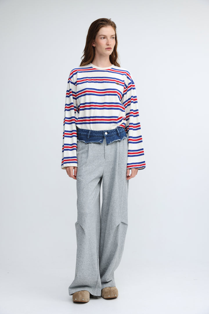 A woman wearing a long-sleeved Federer blue striped shirt with red, white, and blue horizontal stripes visible from front