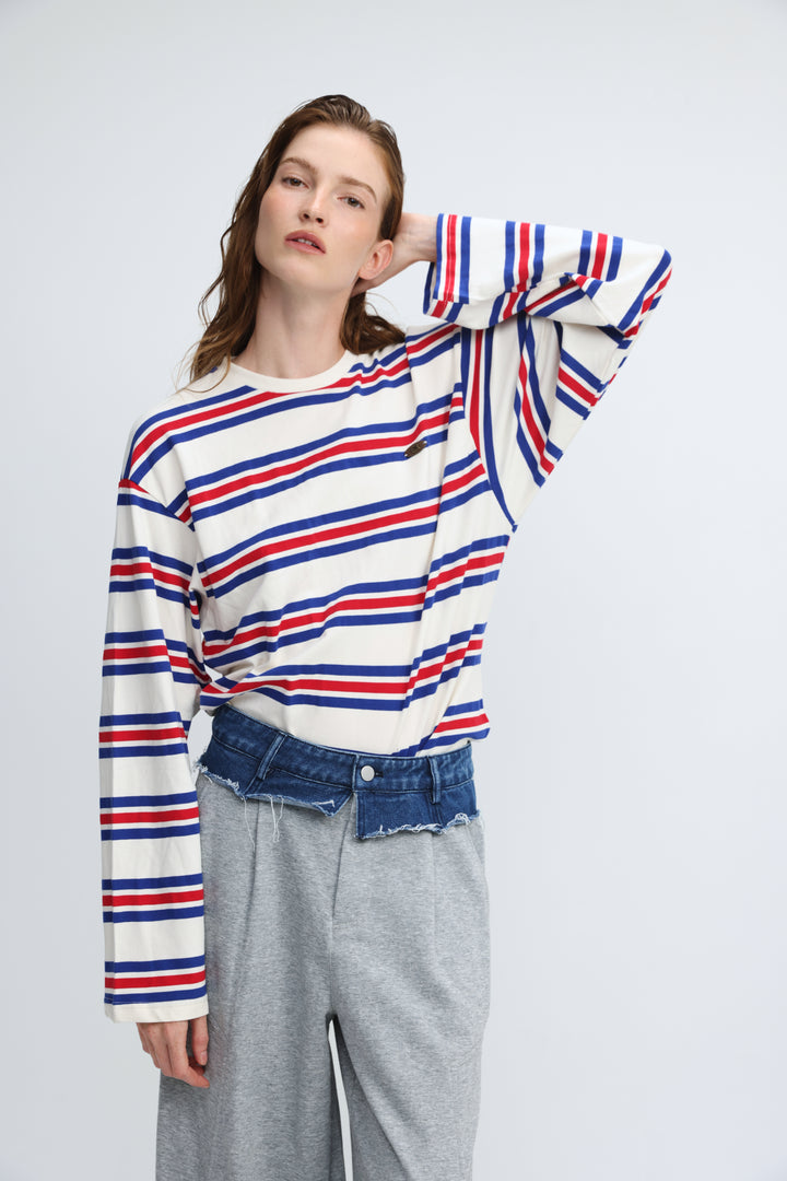 Long-sleeved crew-neck sweater with bold horizontal red, blue, and white stripes shown from the front