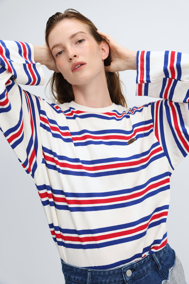 A woman wearing a front view of a long-sleeved crew-neck federation blue striped shirt with bold red and white horizontal stripes