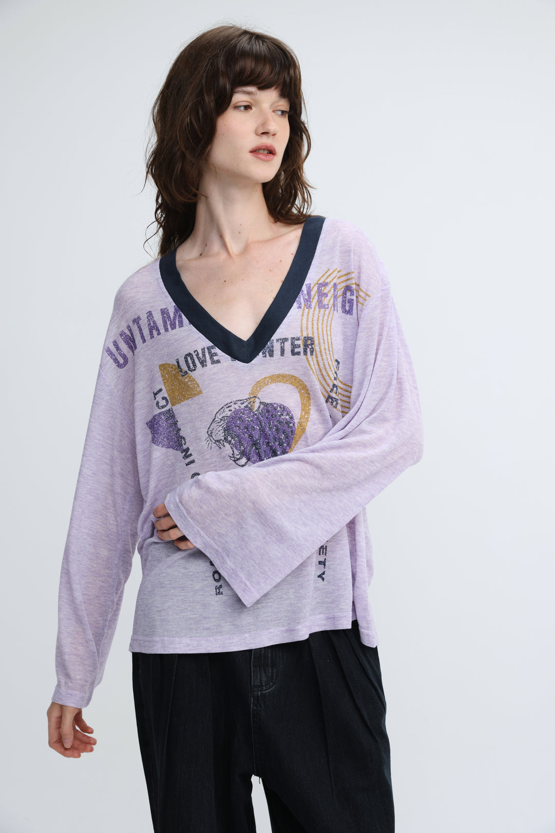 Lavender long-sleeved v-neck top with navy trim and graphic print shown from the front