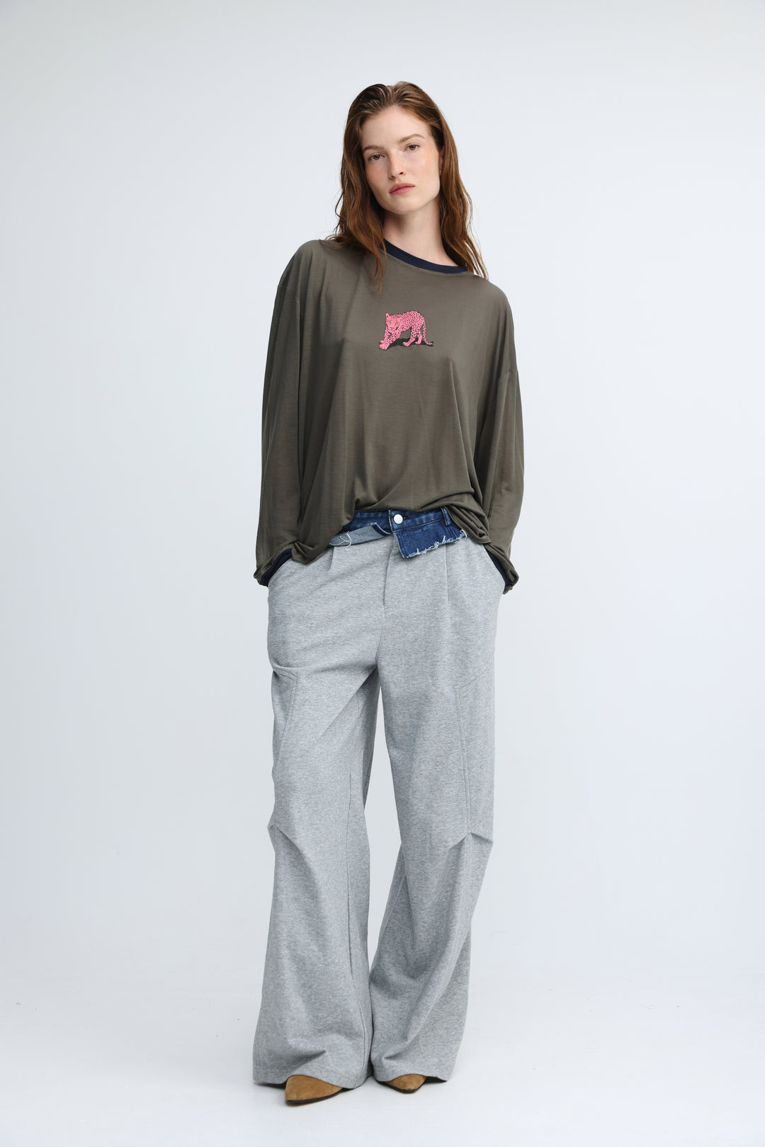 Olive green long-sleeved top with a pink embroidered tiger on the chest shown from the front