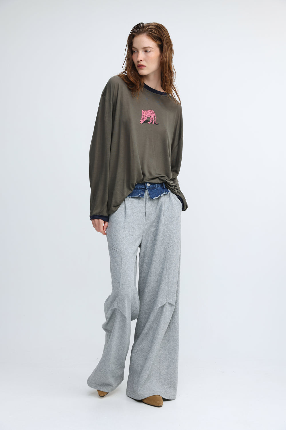 Olive green oversized long-sleeve top with pink embroidered bear on chest shown from the front