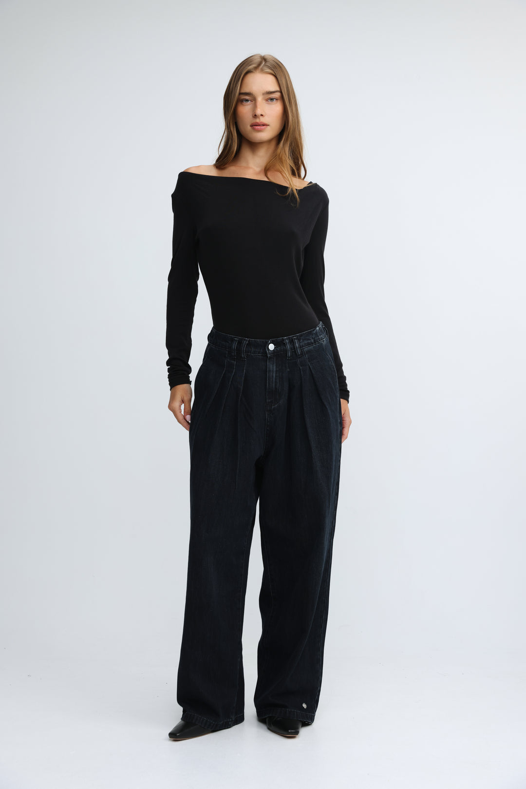 Black off-the-shoulder long-sleeve top with fitted bodice and slightly flared sleeves shown from the front