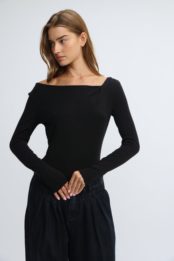 Black off-the-shoulder long-sleeve top with fitted silhouette and ribbed cuffs shown from the front