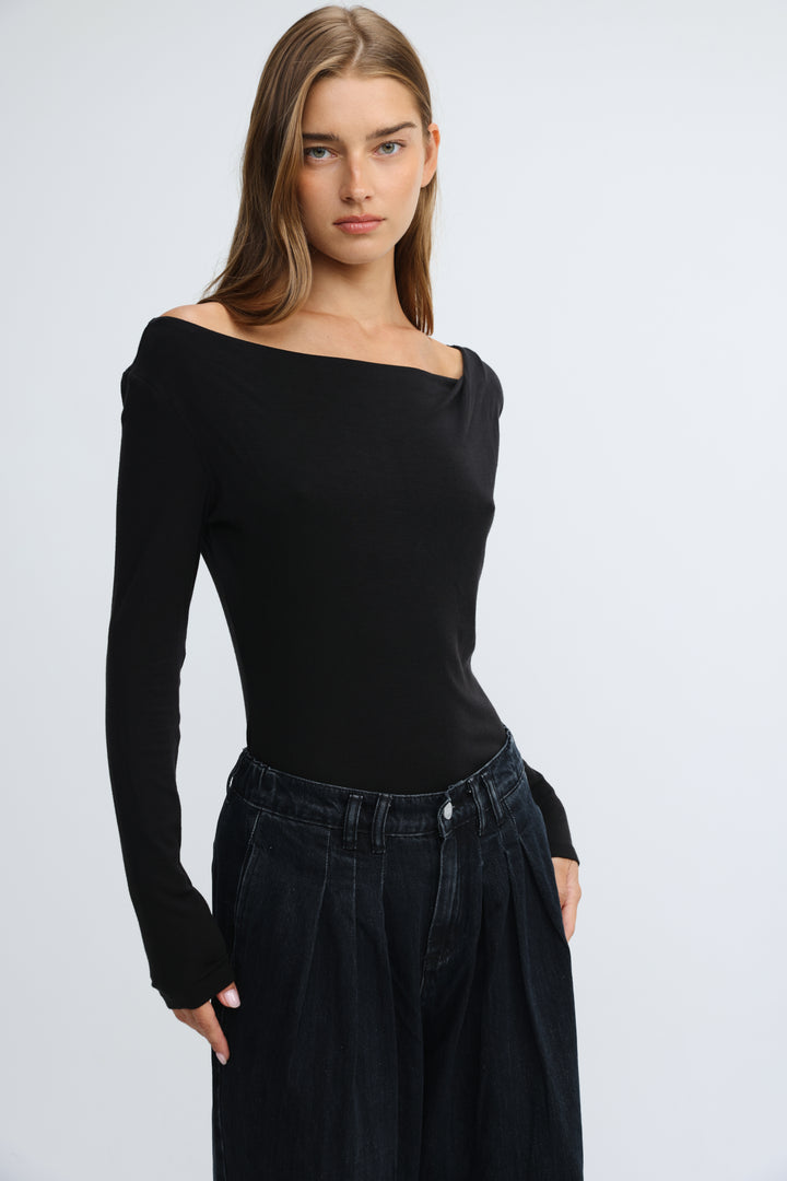 Black off-the-shoulder long-sleeve top with fitted silhouette and ribbed texture shown from the front