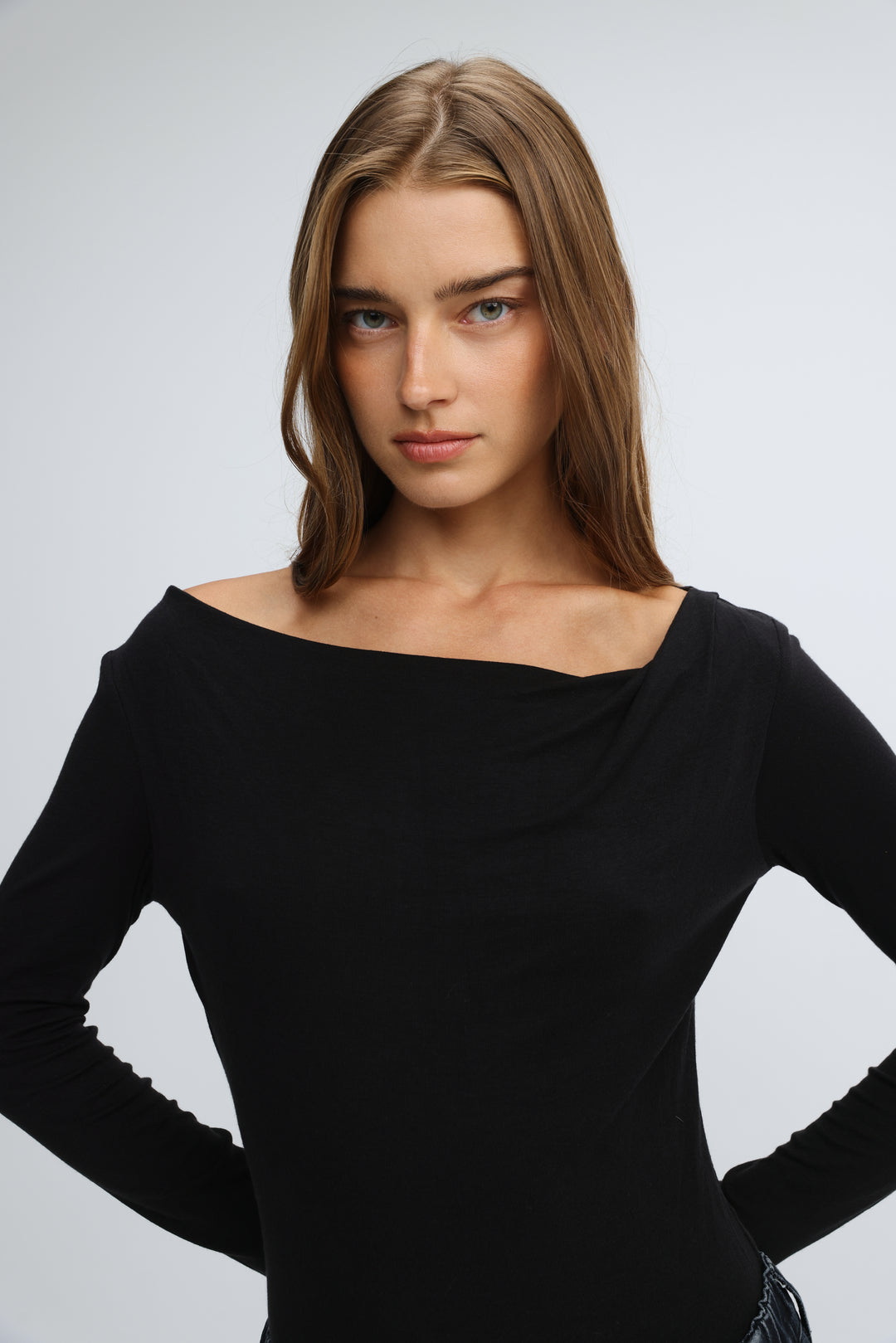 Black long-sleeved off-the-shoulder top with draped neckline and subtle ruching on sleeves front view