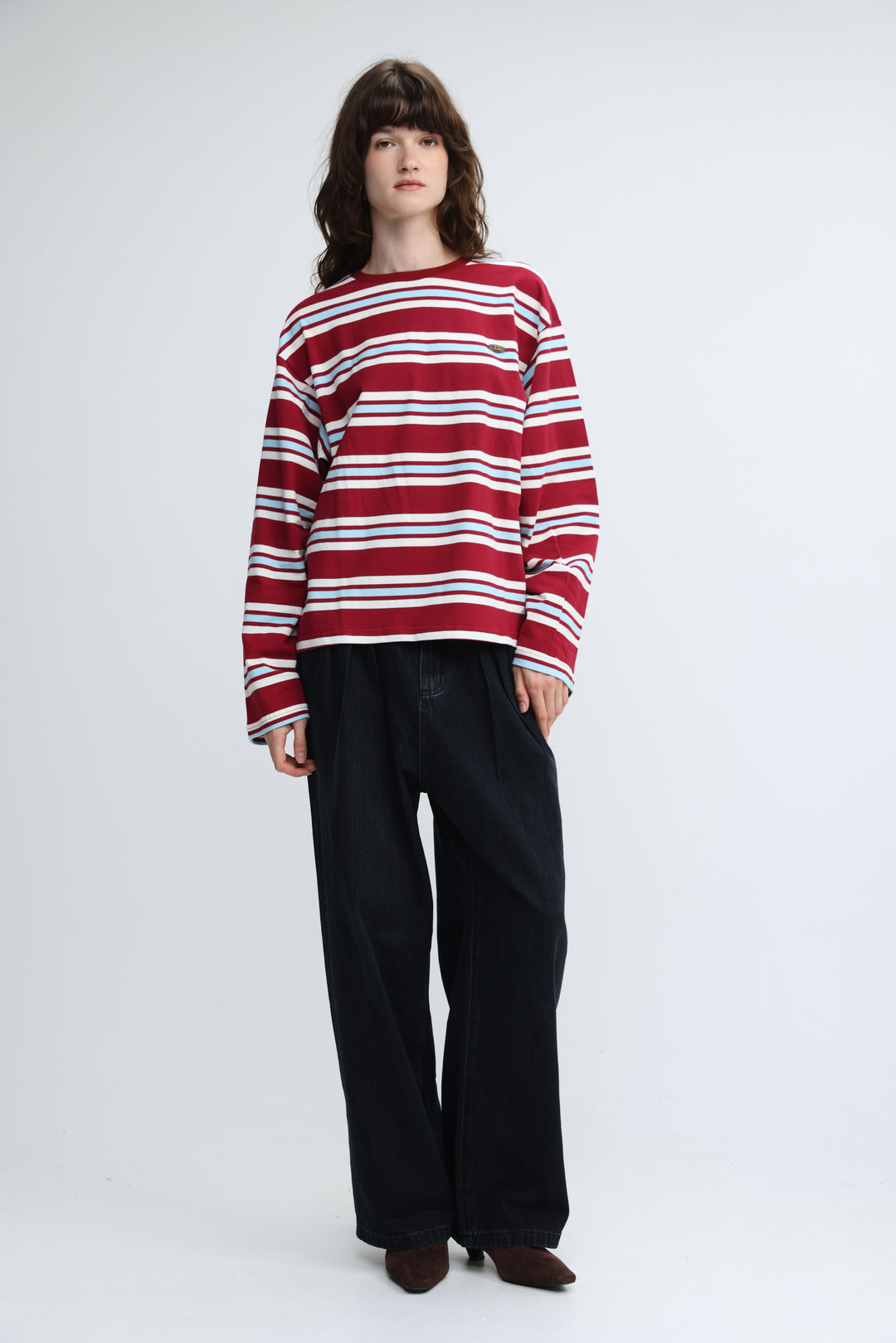 Red and white horizontally striped long-sleeved sweater with round neckline shown from the front