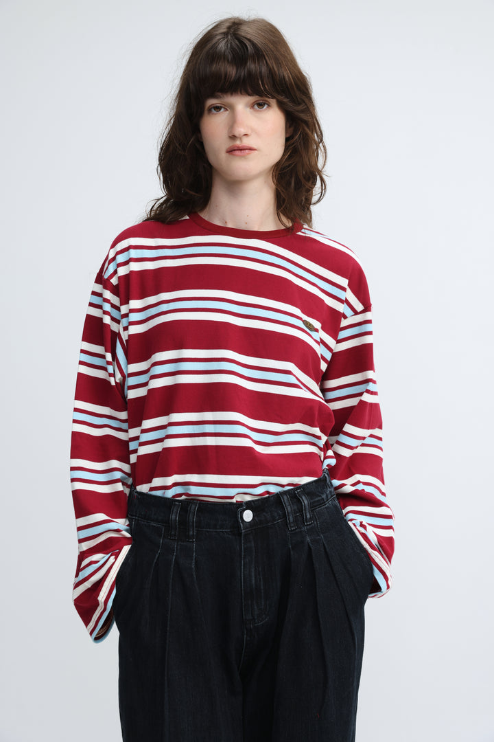 Red, white, and light blue horizontally striped red striped shirt with long sleeves and relaxed fit shown from front
