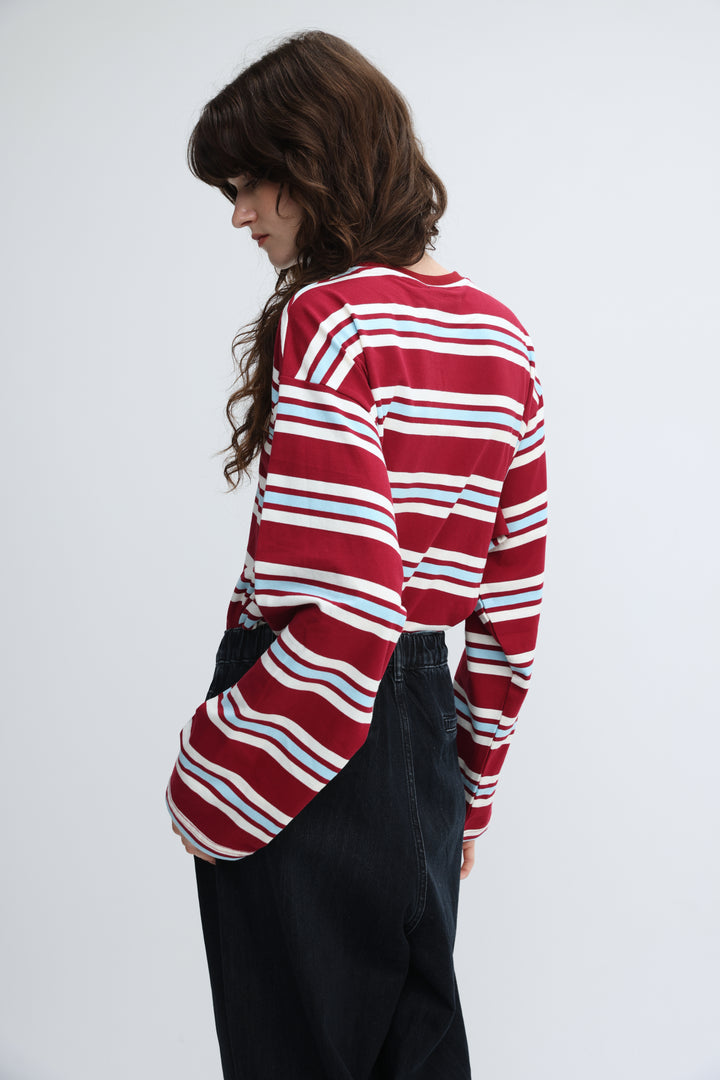 Federer red striped shirt with red white and light blue horizontal stripes and long sleeves shown from the front