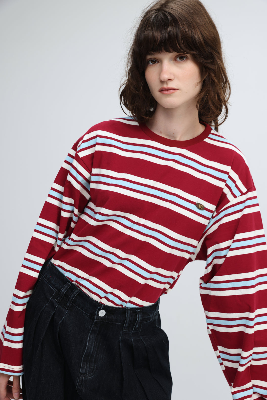 Red striped shirt featuring a red, white, and light blue horizontally striped long-sleeved sweater with a round neckline front view