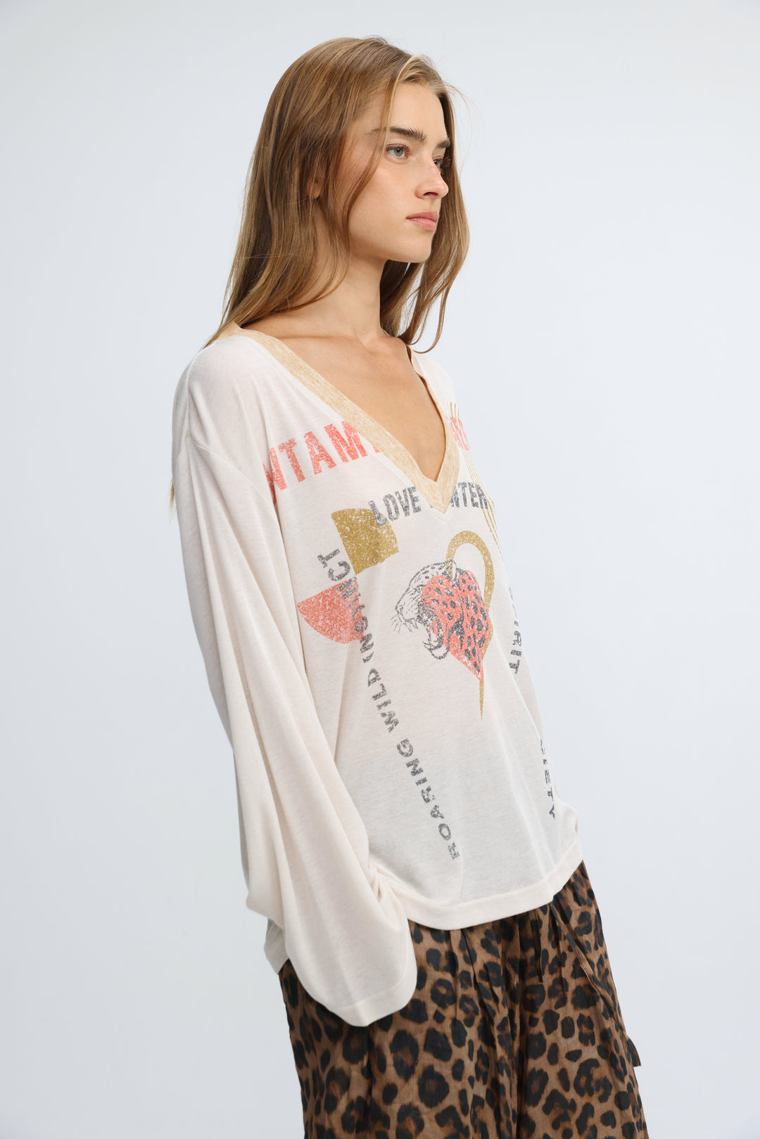 White long-sleeved v-neck jungle cream v shirt with tiger graphic and text print on the front
