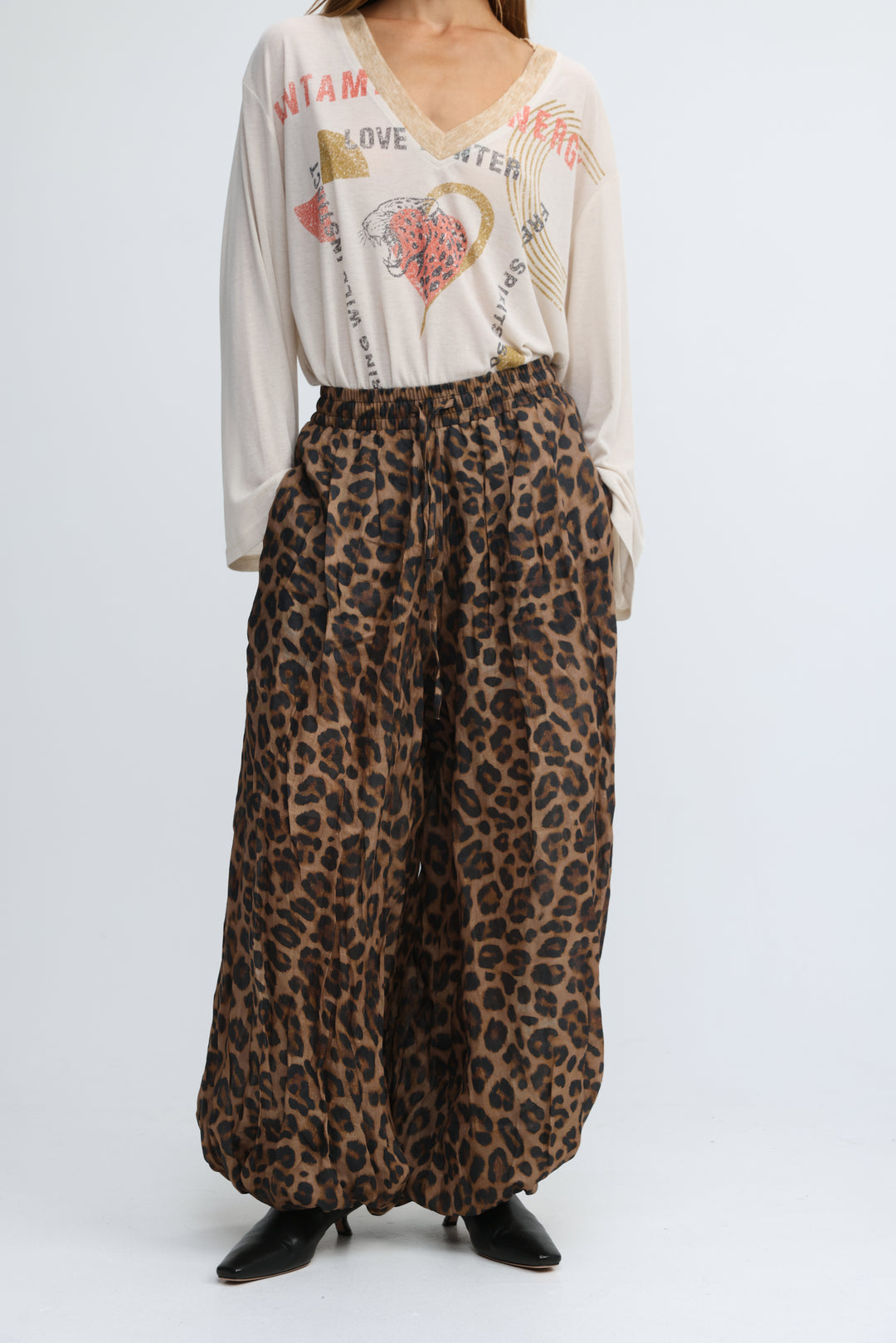 Tender leopard bottoms are leopard-print wide-leg pants in earthy brown and black with a flowing elastic waist design