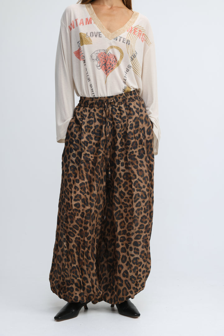 Tender leopard bottoms are leopard-print wide-leg pants in earthy brown and black with a flowing elastic waist design