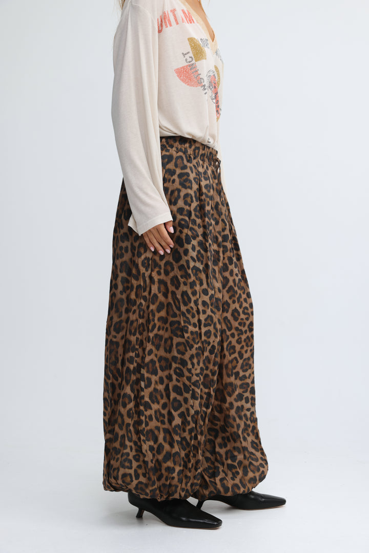 A flowing wide-leg leopard-print maxi skirt in earthy brown and black tones shown from the front