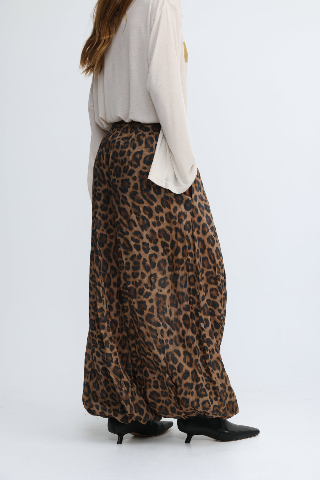 A flowing wide-leg maxi skirt in rich brown and black leopard print shown from the front