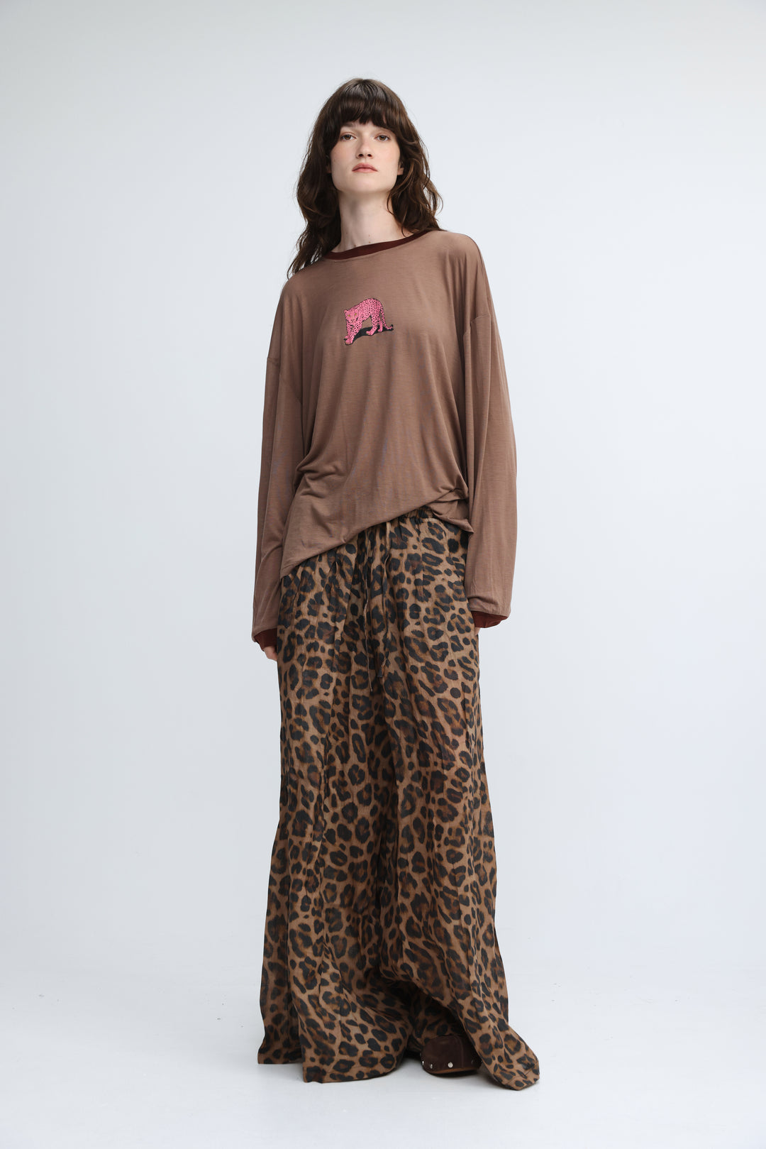 Brown long-sleeved top with a pink embroidered tiger graphic on the chest shown from the front