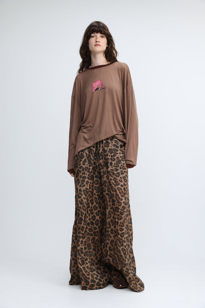 Brown long-sleeved top with a pink embroidered tiger graphic on the chest shown from the front