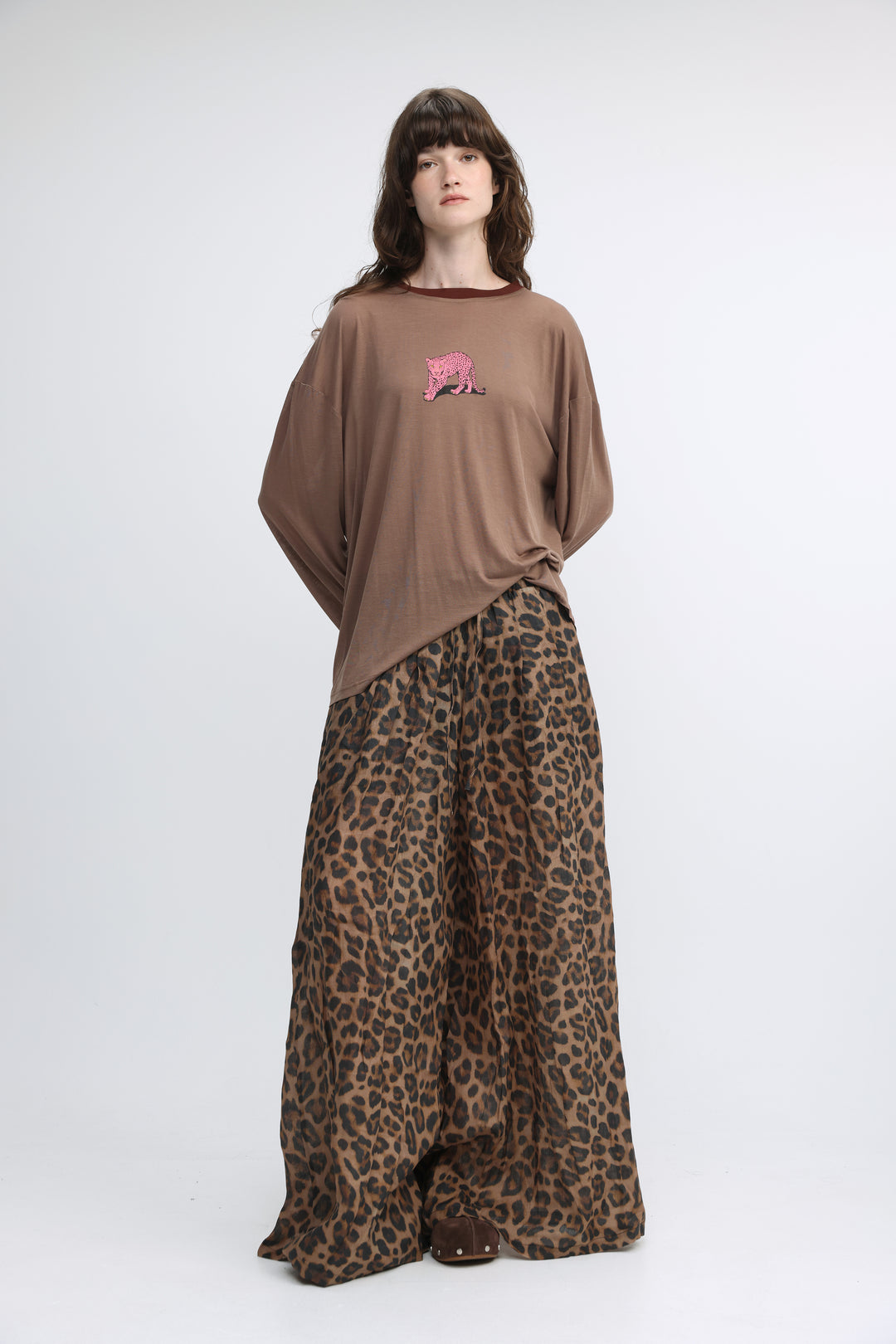 Brown oversized t-shirt with a pink embroidered tiger on the chest shown from the front