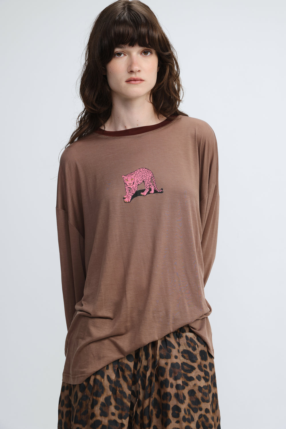 Brown long-sleeved top with pink leopard embroidery on the chest shown from the front titled pink tiger brown shirt