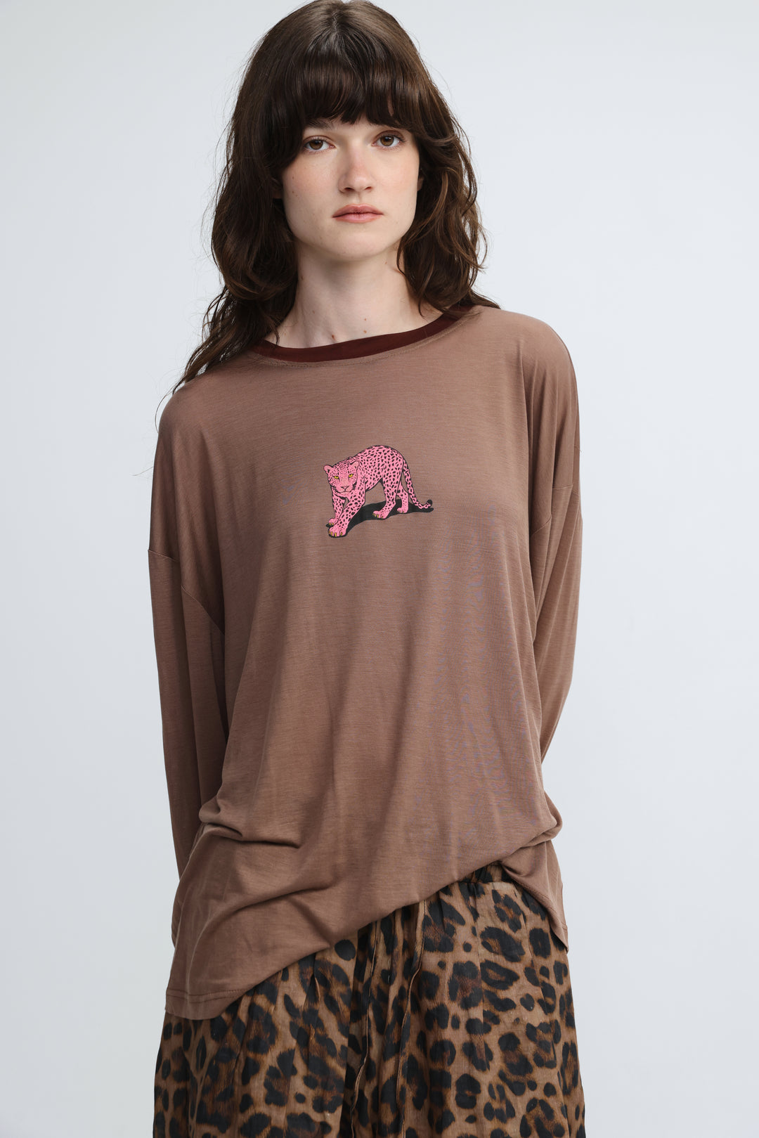 Brown long-sleeved top with pink leopard embroidery on the chest shown from the front titled pink tiger brown shirt