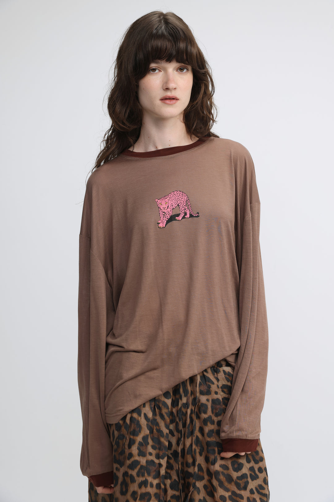 Brown long-sleeved shirt with pink leopard embroidery on the chest and dark brown trim at neckline and cuffs front view