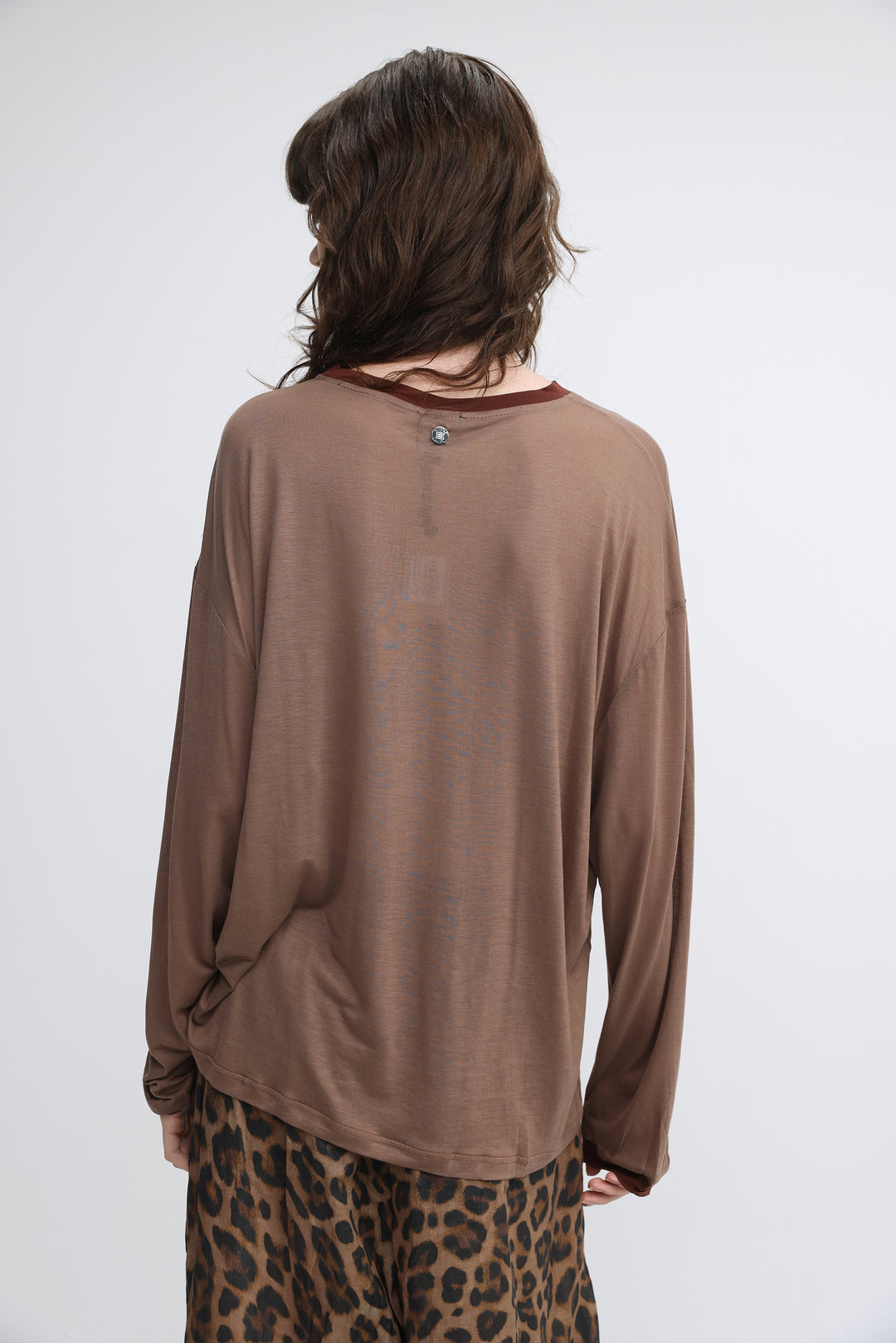 Pink tiger brown loose-fitting long-sleeved top with subtle sheen and small metallic button at the neckline front view