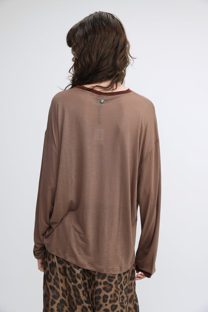 Pink tiger brown loose-fitting long-sleeved top with subtle sheen and small metallic button at the neckline front view