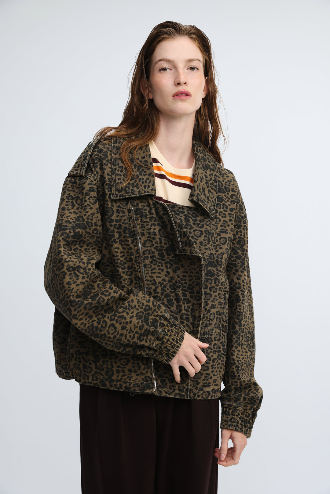 Olive green leopard print denim jacket with relaxed fit and rolled cuffs shown from front view