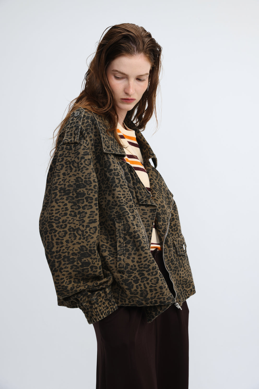 Olive green leopard-print denim jacket with front zipper closure and relaxed oversized fit shown from front