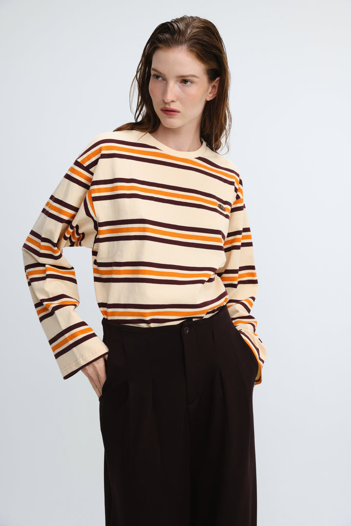 Long-sleeved orange striped sweater with horizontal cream and dark brown stripes shown from the front