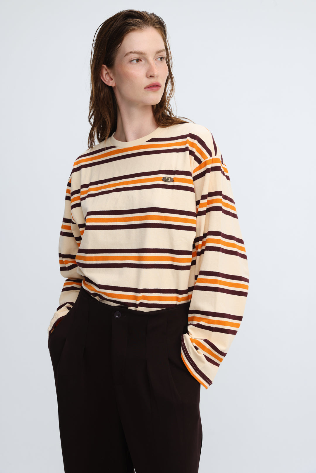 Cream-colored long-sleeved Federer orange striped shirt with bold orange and dark brown horizontal stripes and green logo patch front