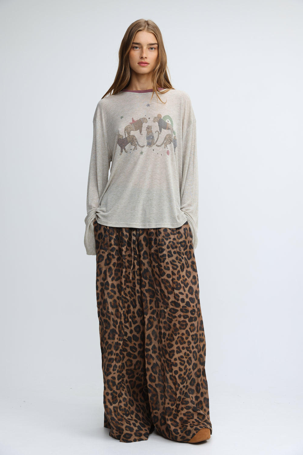 Jungle grey shirt featuring a light gray long-sleeved tee with a subtle graphic print of stylized animals and stars across the chest