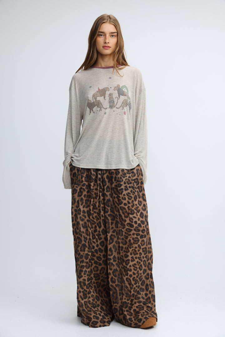Jungle grey shirt featuring a light gray long-sleeved tee with a subtle graphic print of stylized animals and stars across the chest