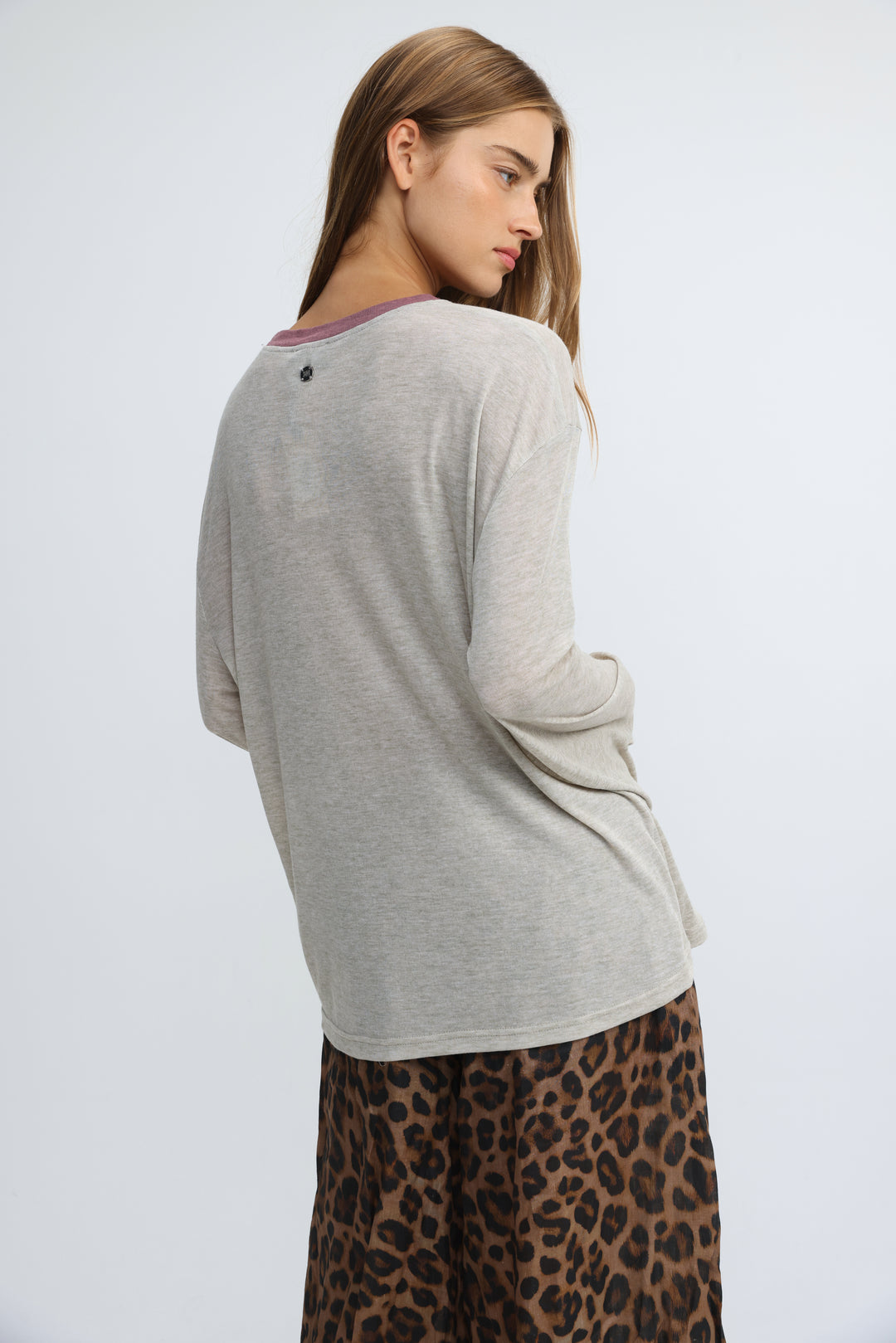 Jungle grey shirt with a soft heather gray long sleeve and subtle purple trim at the neckline viewed from the front