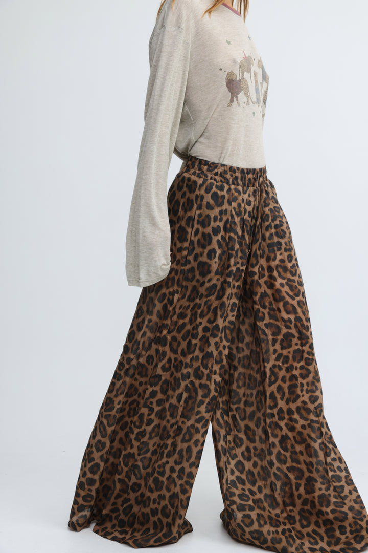 Wide-leg leopard-print trousers in beige with a flowing silhouette shown from the front