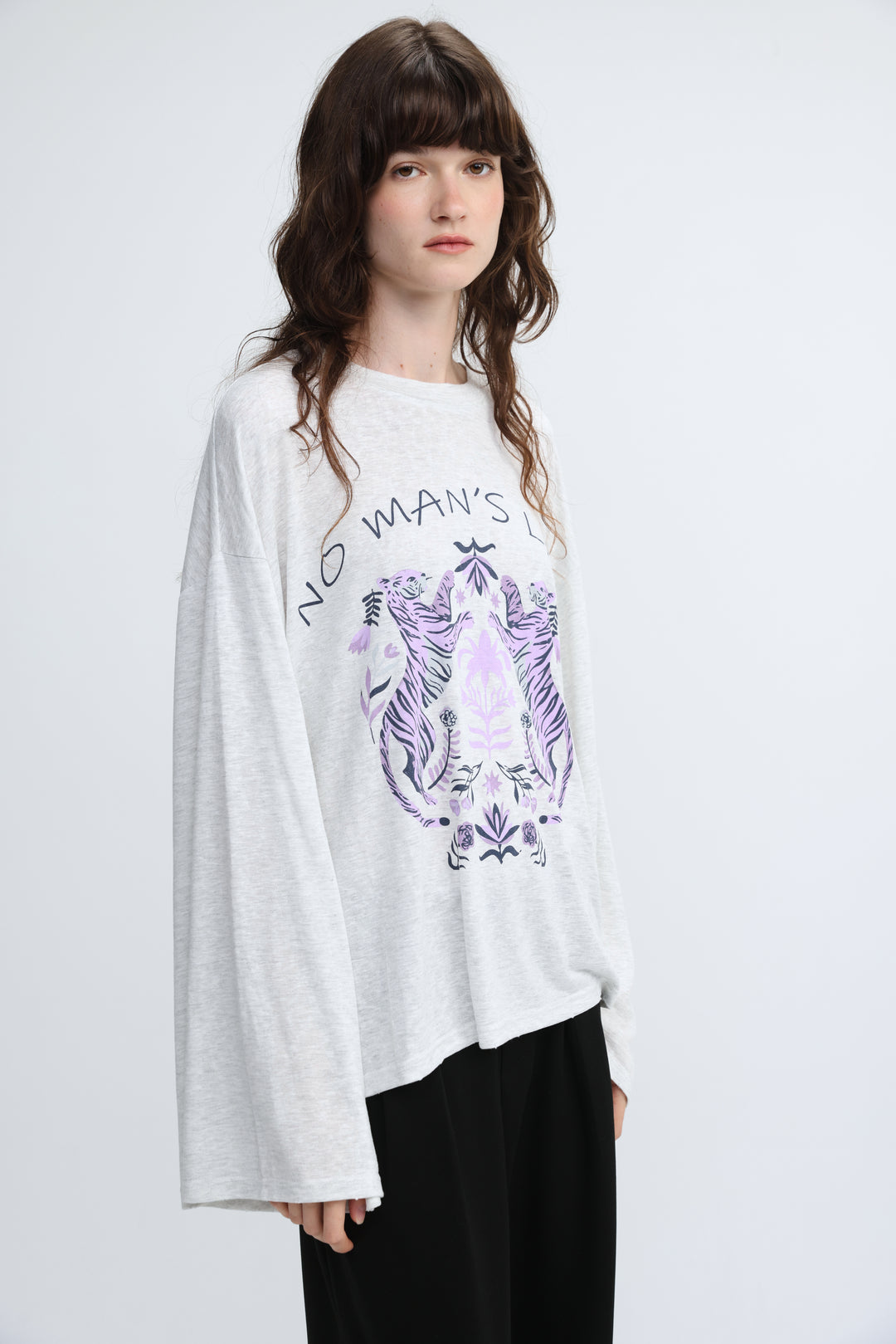 White long-sleeved tee with purple and black tiger illustration and the text no mans l across the chest front view