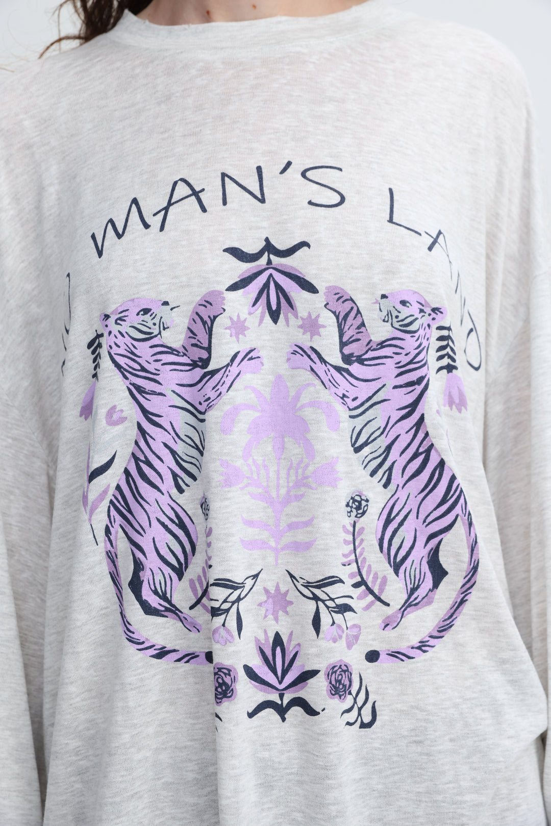 Heather gray long-sleeved tee with bold purple and black graphic of two tigers facing each other and mans land text