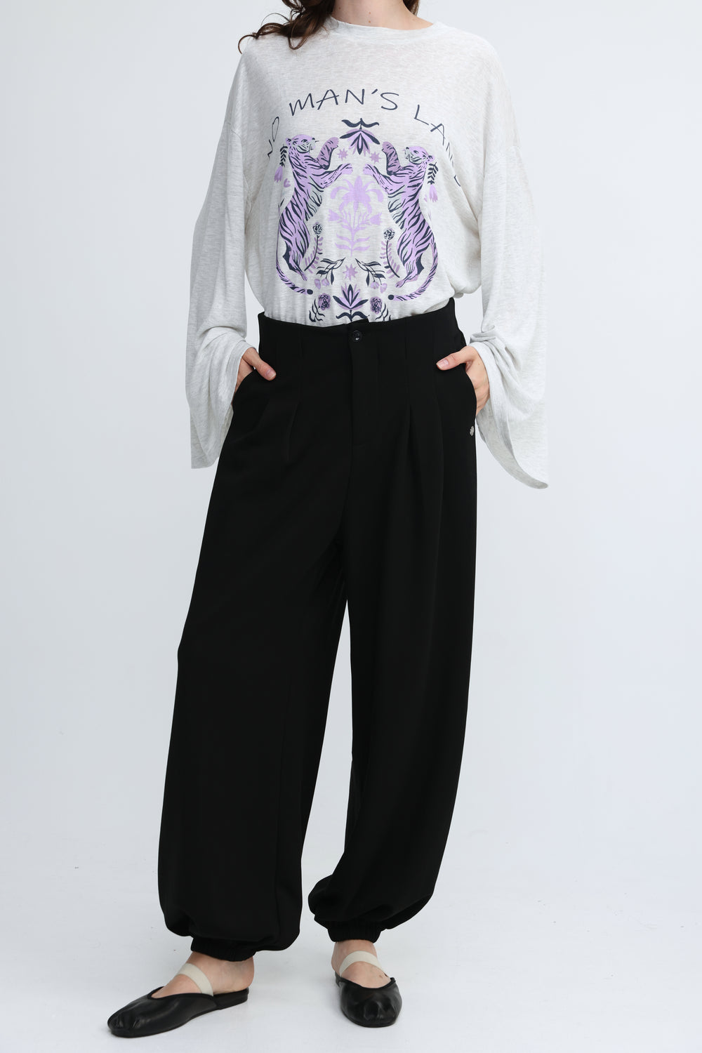 White long-sleeved top with purple tiger and floral graphic paired with everything black bottoms shown from front view